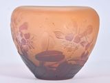 a glass vase that has a flower design on it