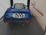 a model of a blue race car in a display case