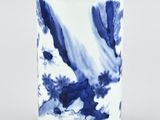 a blue and white vase sitting on a table