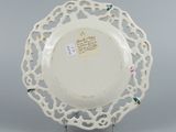 underside view of a white plate with a floral design on it