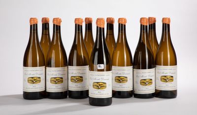 six bottles of wine are lined up in a row on a white surface