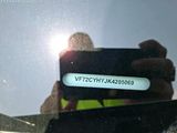 reflection of a person taking a picture of themselves in a car window