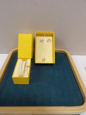 a small tray with a ring and a watch on it