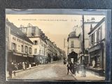an old photo of a city street with people walking down it