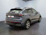 the rear end of a grey volkswagen suv parked in a showroom