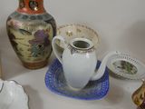 many different types of vases and plates on the table
