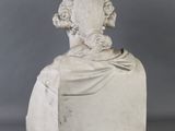 a white marble bust of a man with a long hair