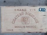 a wooden box with a label on it sitting on the ground