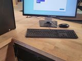 a desktop computer sitting on a desk with a keyboard and mouse
