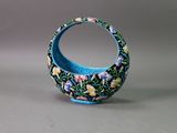 a small blue vase with a floral design on it