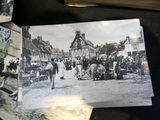 a black and white photo of a group of people walking down a street
