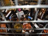 many bottles of wine in a metal basket on the table