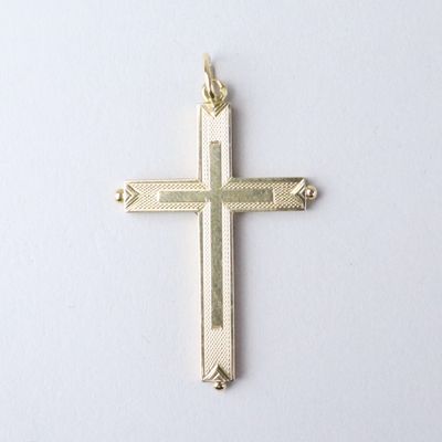 a gold cross on a white background