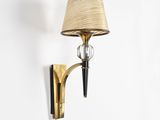 a close up of a lamp on a wall with a shade on it