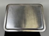 stainless steel tray on black surface with white background