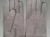 pair of gray leather gloves on a white surface
