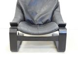 a black leather chair that is on a white background