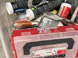 a plastic container filled with assorted items on the floor