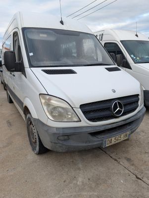 two white vans parked in a lot next to each other