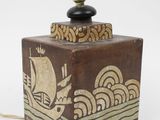 a small wooden box with a lamp on top of it