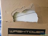 a cardboard box with a hole in it that says wash tower