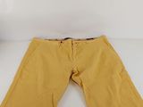 a pair of yellow pants sitting on top of a white table