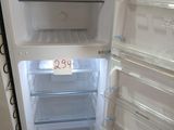an open refrigerator with its door open and the door is empty