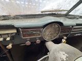 dashboard of an old car with a broken windshield and steering wheel