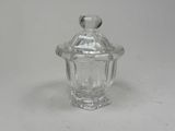 clear glass jar with a lid on a white surface