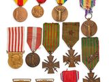 an assortment of medals and medals are displayed on a white surface