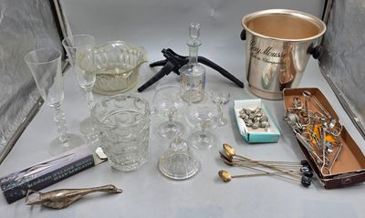 une table sur laquelle sont disposés divers objets en verre et en argent