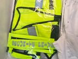 a yellow vest and a pair of white pants on a table
