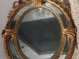 a mirror hanging on the wall in the corner of a room