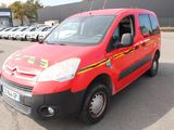 a red van that is parked in a parking lot