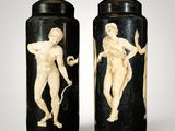 pair of black and white vases with a man and a woman on them