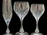 three empty wine glasses sitting next to each other on a black background