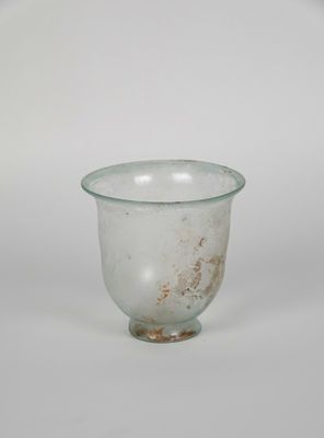 a small glass cup sitting on top of a white table