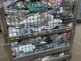 a metal cart with many items in it in a warehouse