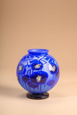 a blue vase sitting on top of a black stand