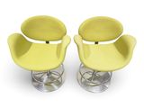pair of yellow swivel chairs with chrome base and footrests
