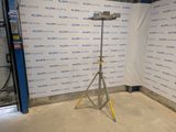 a camera on a tripod in front of a wall