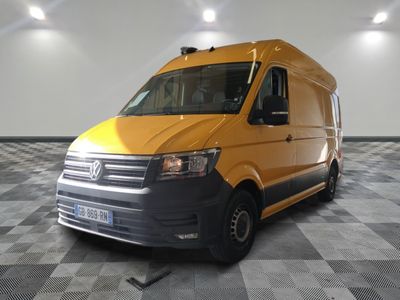 the yellow van is parked on a checkered floor in the garage