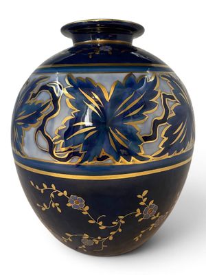 a blue and gold vase with a dragon on it