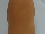 a brown vase with a black face and a hat on it