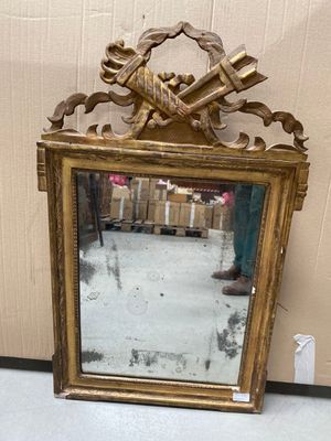 a mirror that is sitting on the floor next to a wall