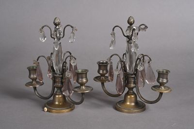 pair of antique brass candelabs with crystals on each of them