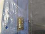 a bag of clothes that is sitting on a bed