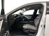 the interior of a white truck with the door open and the passenger seat down
