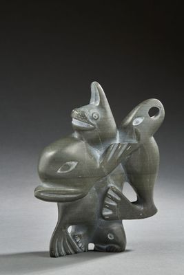 statue of a fish holding a bird on its back