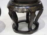 two black and gold stools sitting next to each other